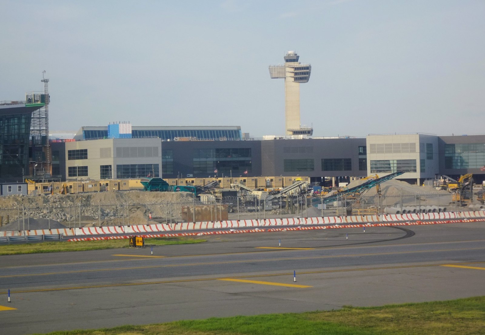 Photograph of the New Terminal One structure under construction at JFK with the control tower behind
