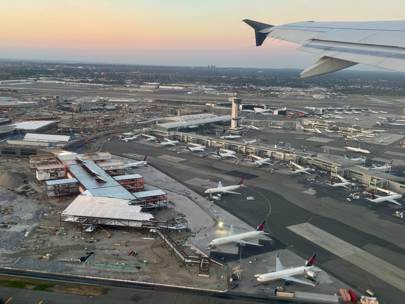 Elevated photograph of the Terminal 4 apron at JFK with parked aircraft at the gates and the terminal building behind